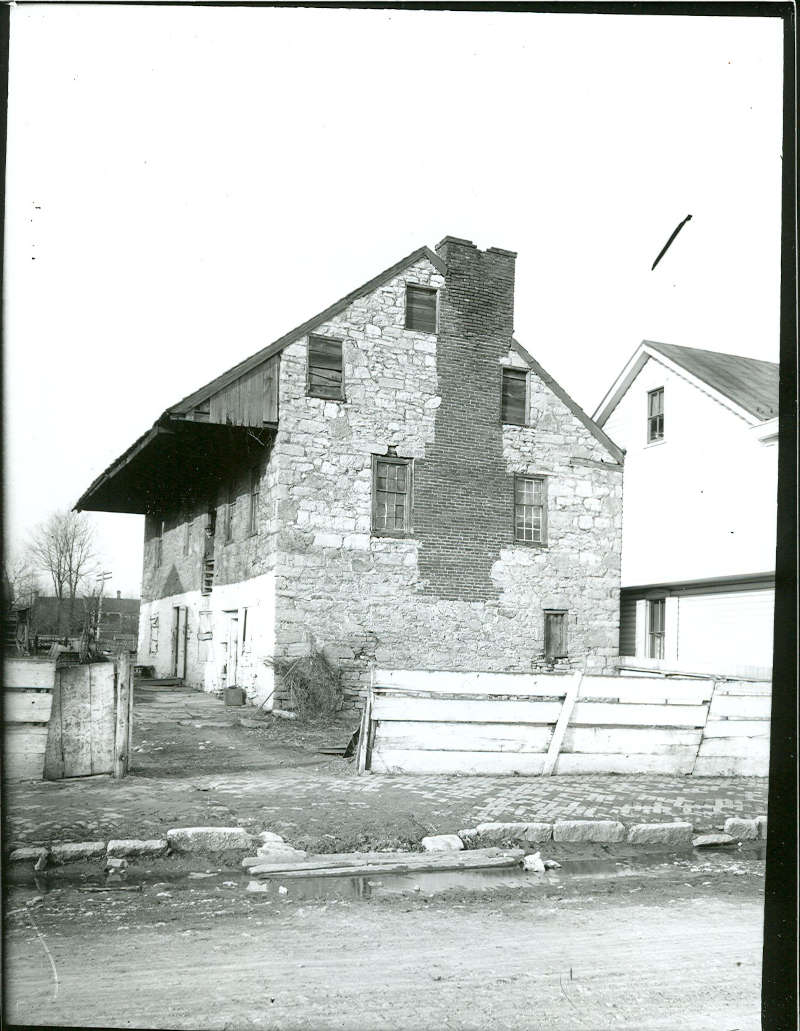 View from South Street of the chimney and end of the old distillery that collapsed in 1908.  Taken c. 1900 by A. A. Line.