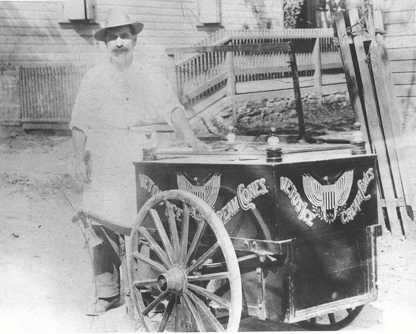 Image of Charles Veto with his pushcart. Sign reads Veto's Ice Cream Cones.