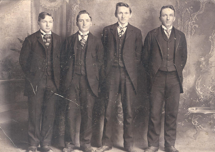 Studio portrait of the four Mountz brothers, John, Harvey, Ira and Aaron, dressed in three piece suits.